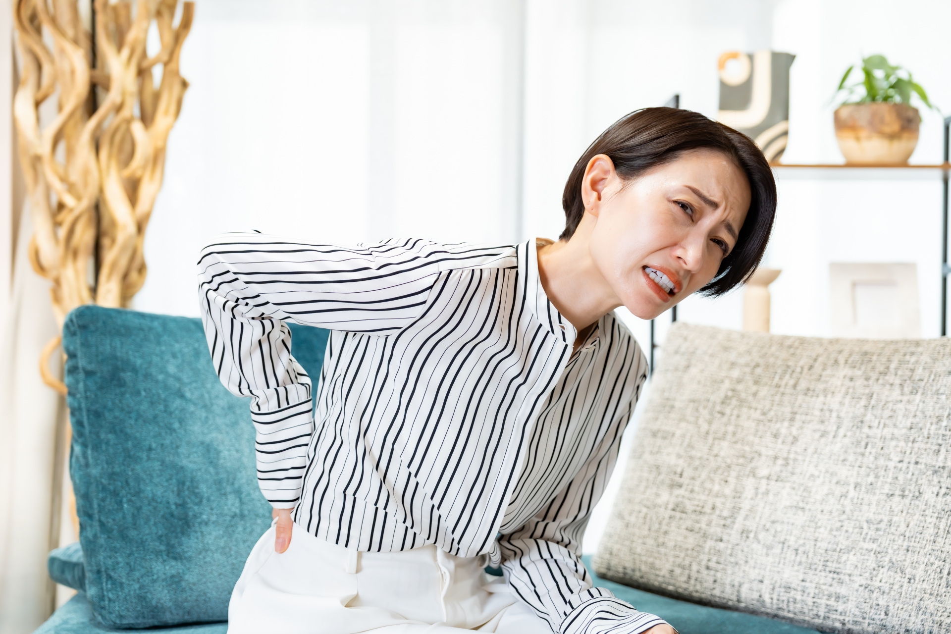 腰痛に悩む女性